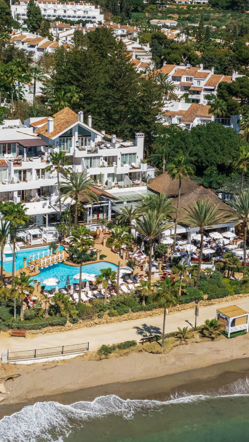 Aerial view of Puente Romano’s pool, palms and beach
