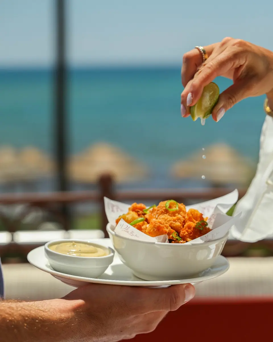 Fried baby squid with aioli served on a terrace above the sea