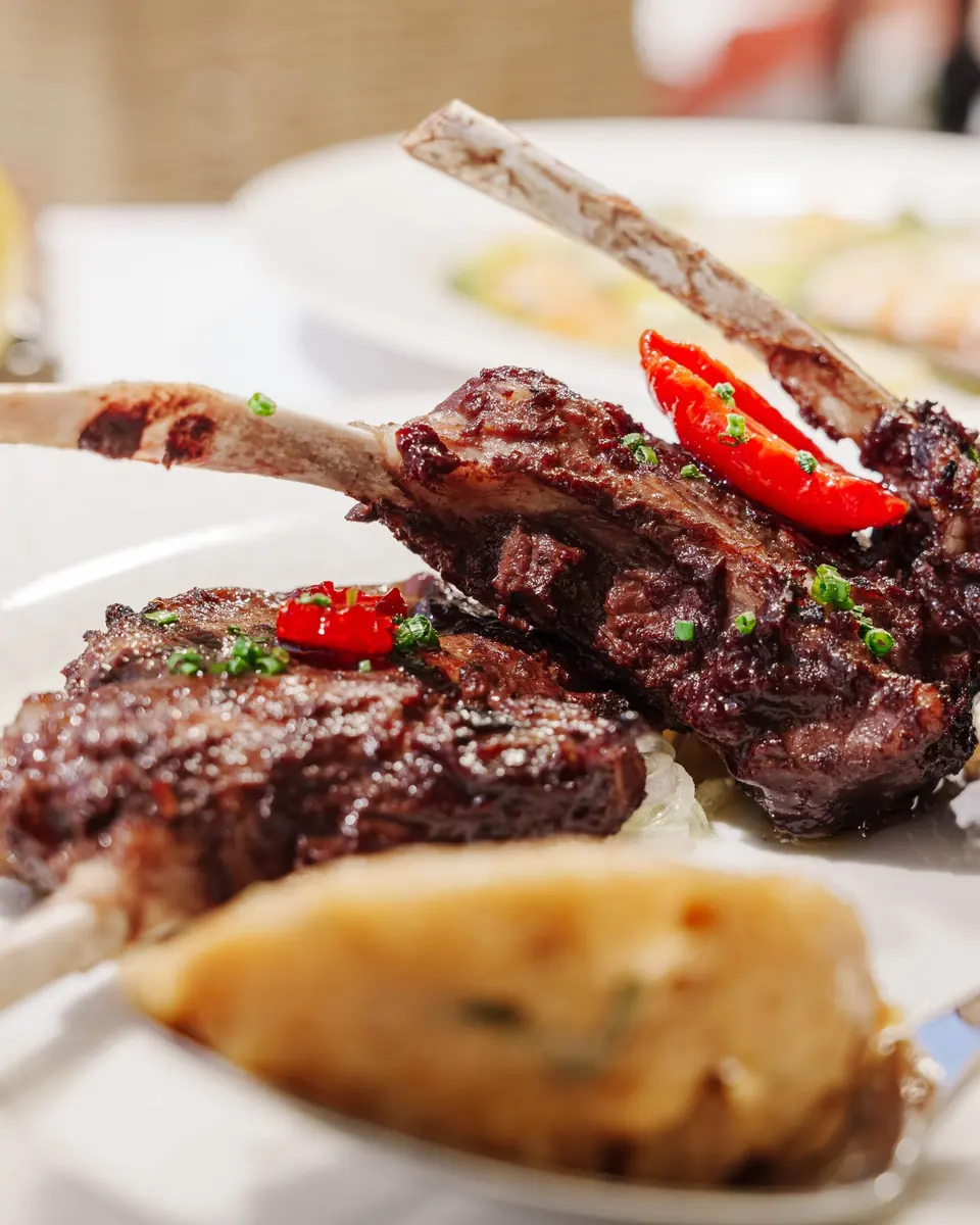 Grilled lamb cutlets with red chilli and a gratin